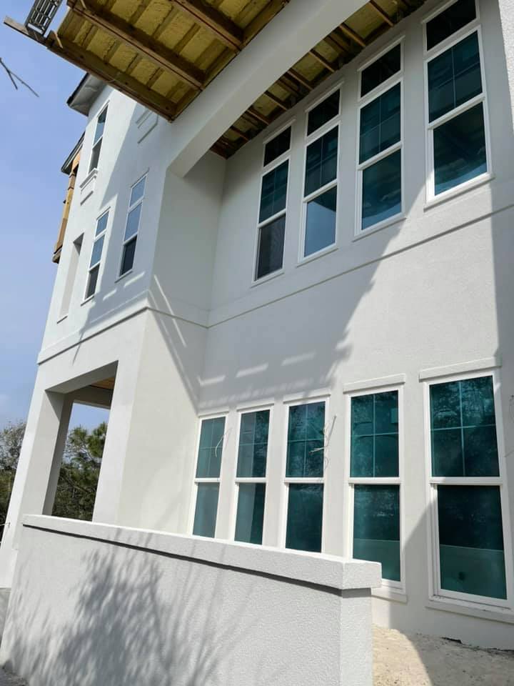 White stucco facade with a row of windows and crisp exterior detailing